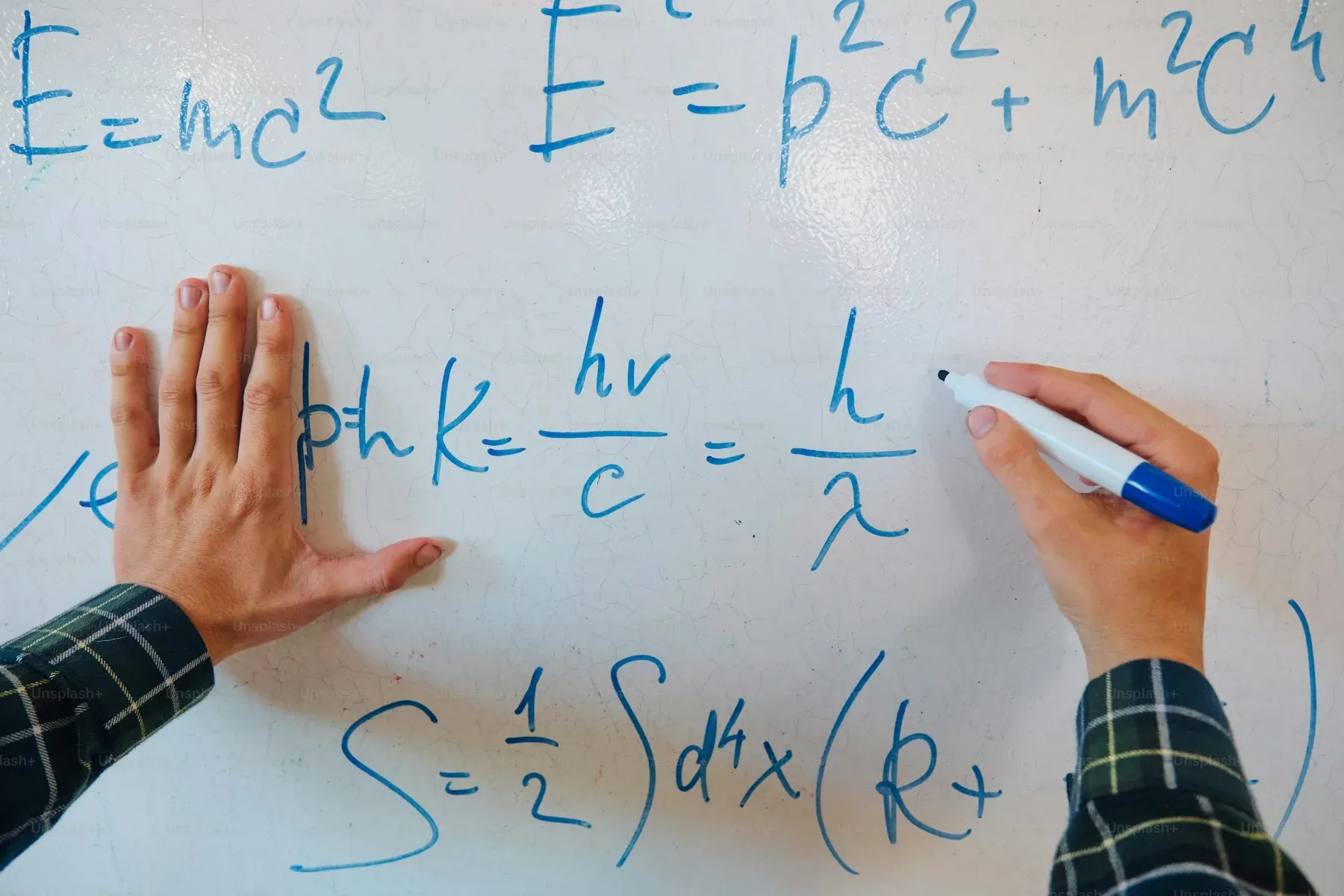 Equations written on a whiteboard
